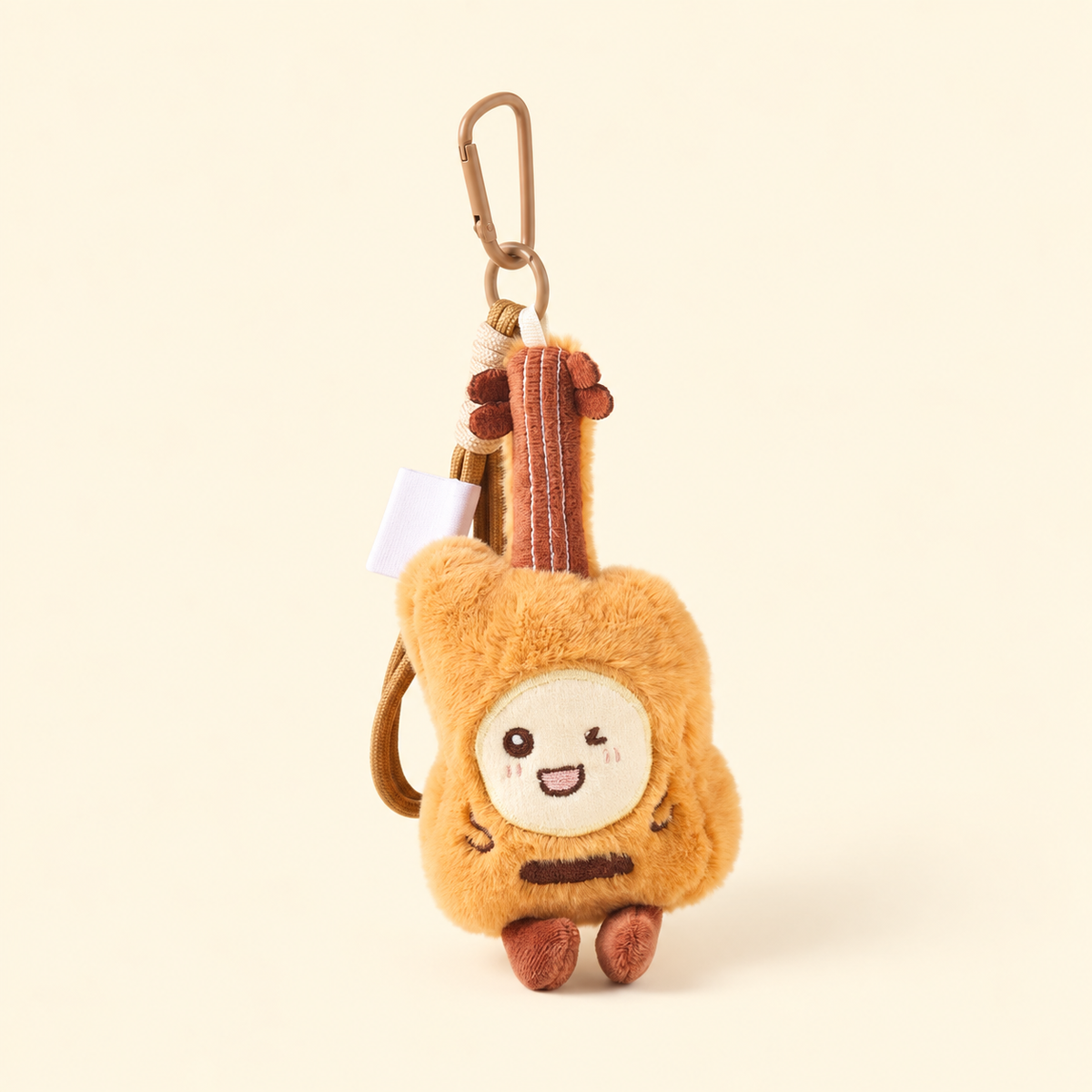 guitar tan plush instrument bag charm on ivory background