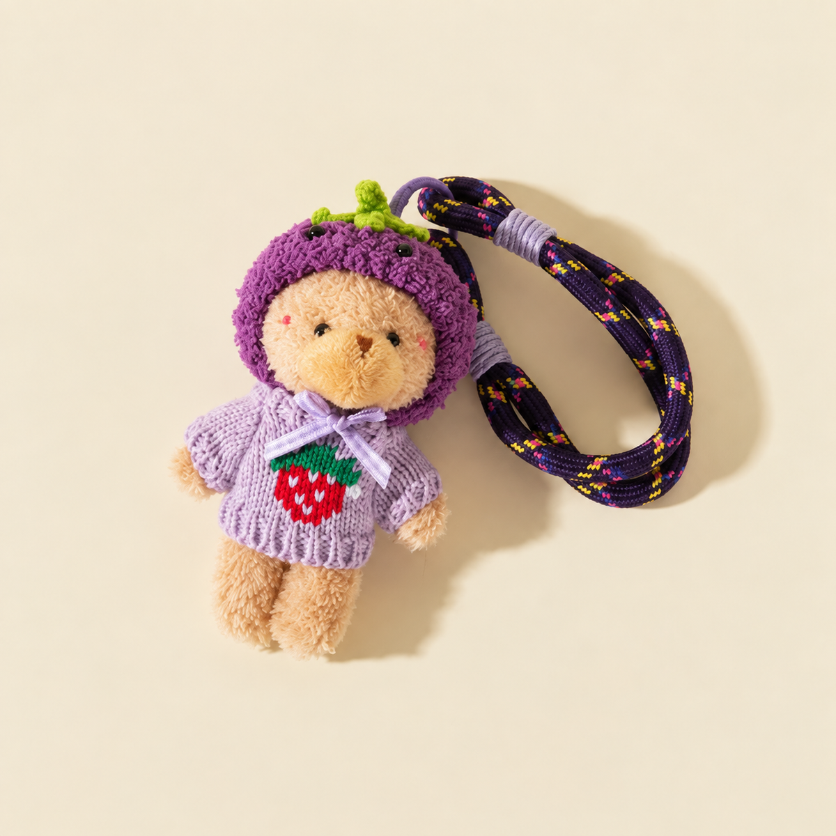 purple hooded sweater bear with rope loop on ivory background