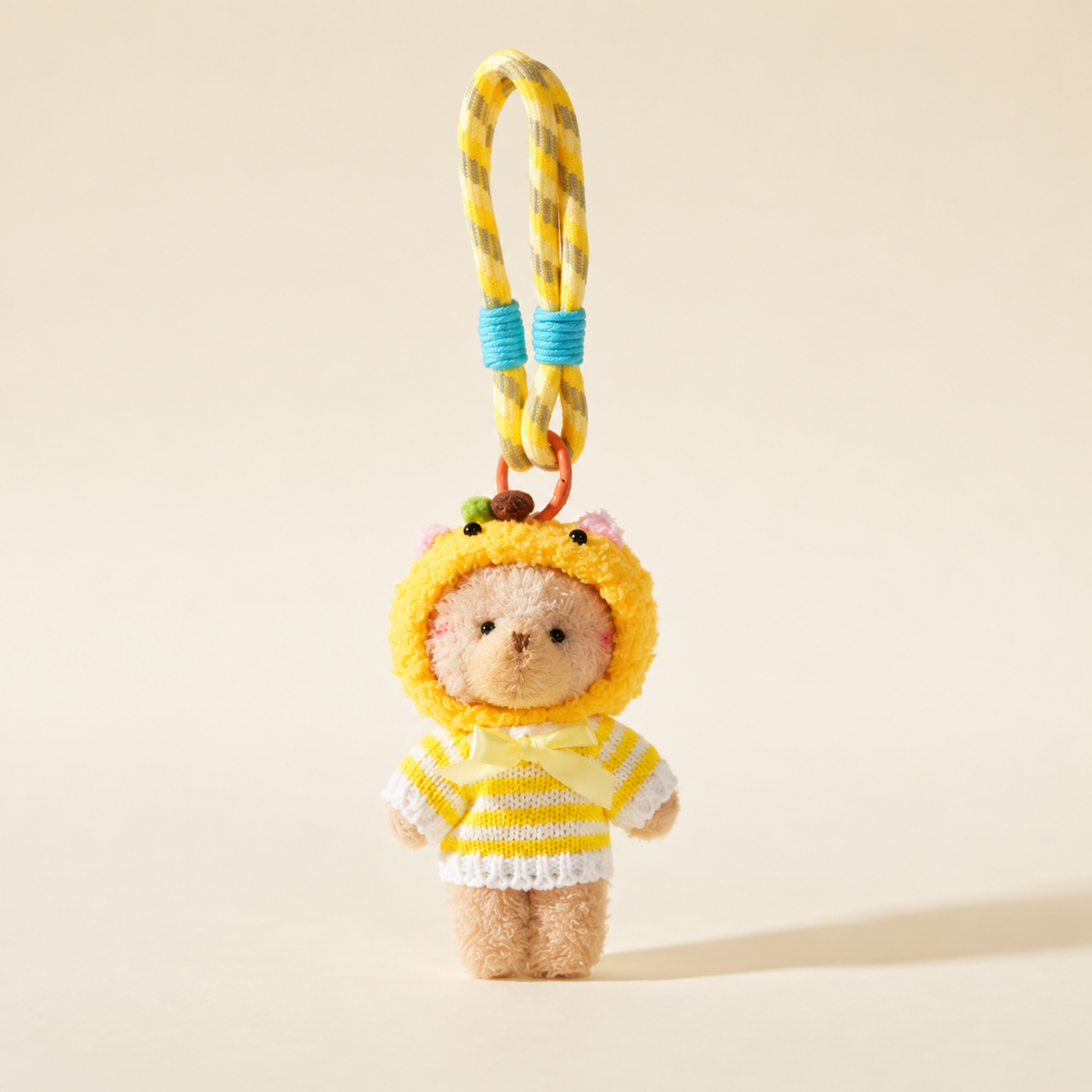 yellow hooded sweater bear with rope loop on ivory background