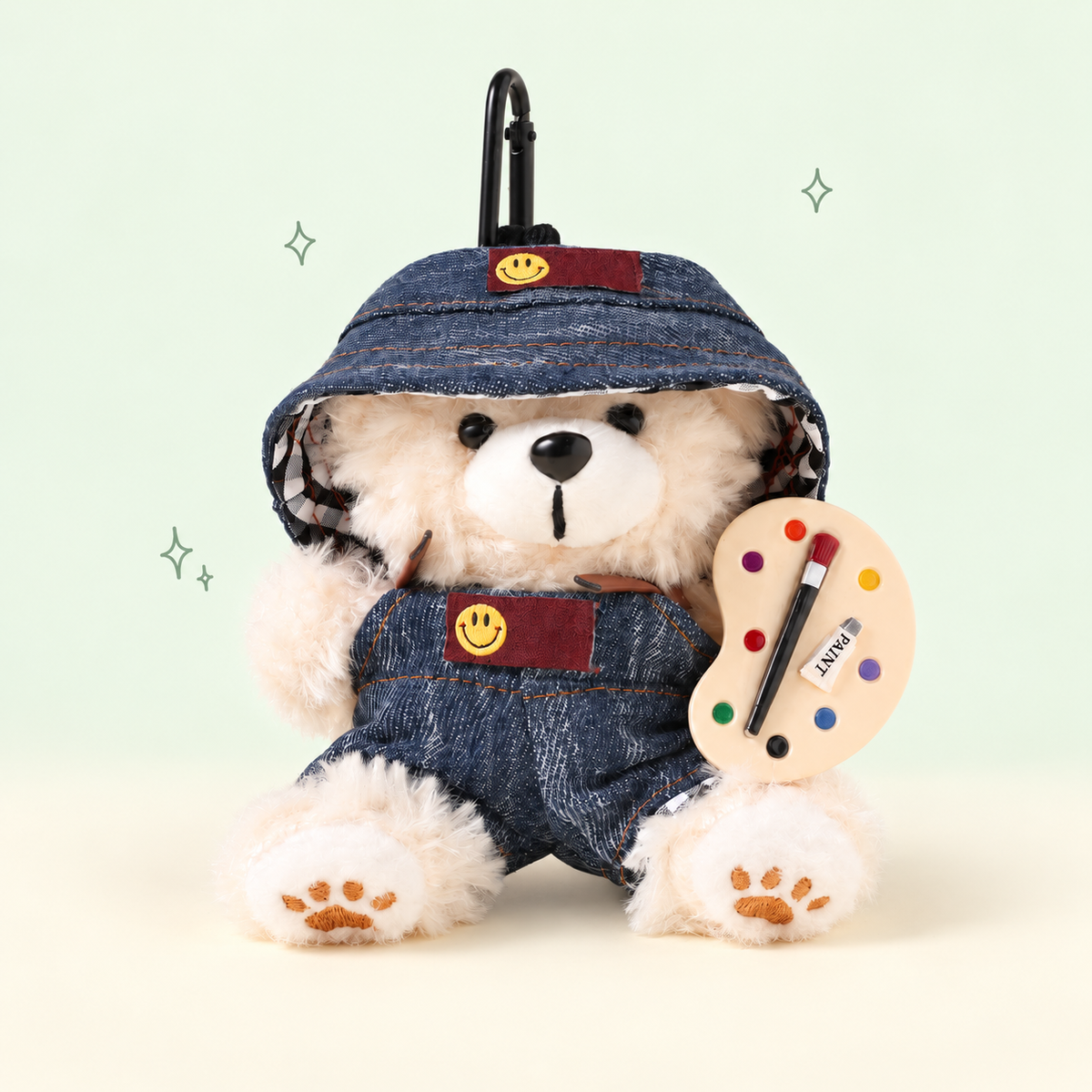 Bucket Hat Painter Bear Plush Bag Charm on a soft pastel background