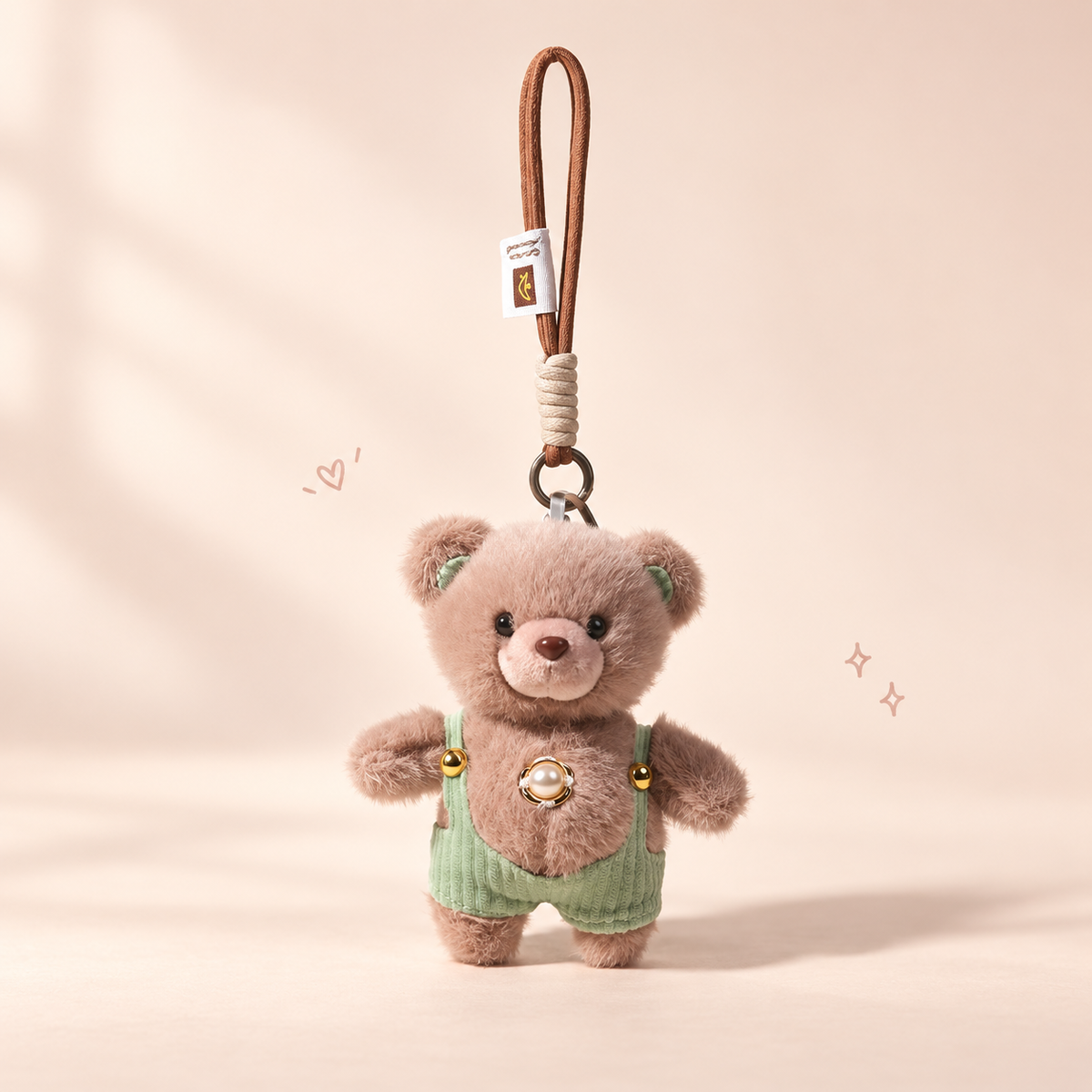 Charming Teddy Plush Keychain on a softly lit cream and pastel background.