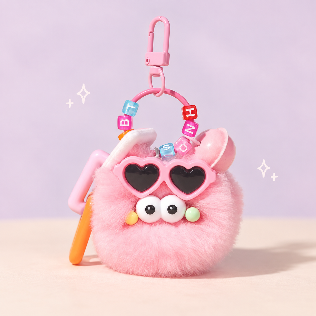 Sunnyball Plush Charm on a softly lit cream and pastel background.