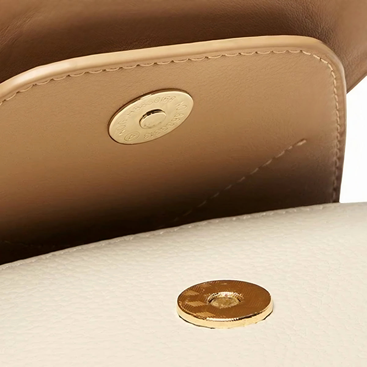 Close-up of the gold-tone magnetic snap and stitched flap