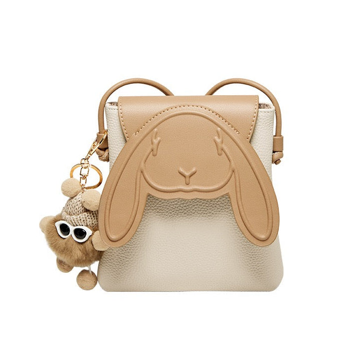 Khaki rabbit mini crossbody bag with cream body and playful charm on a white background