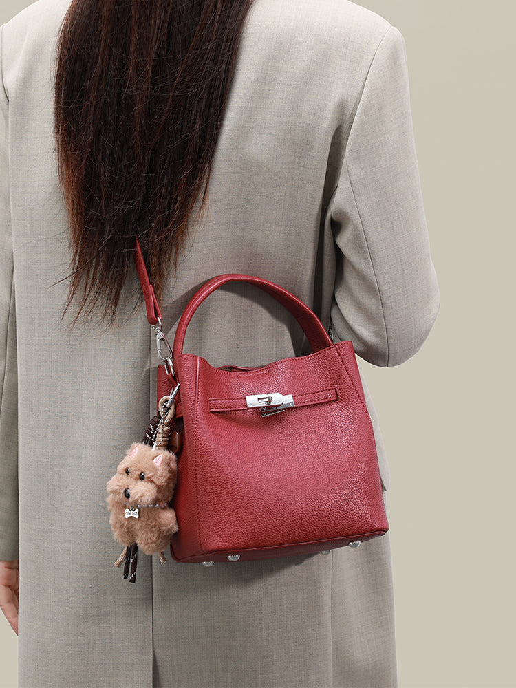 Wine red mini bucket bag worn crossbody from the back