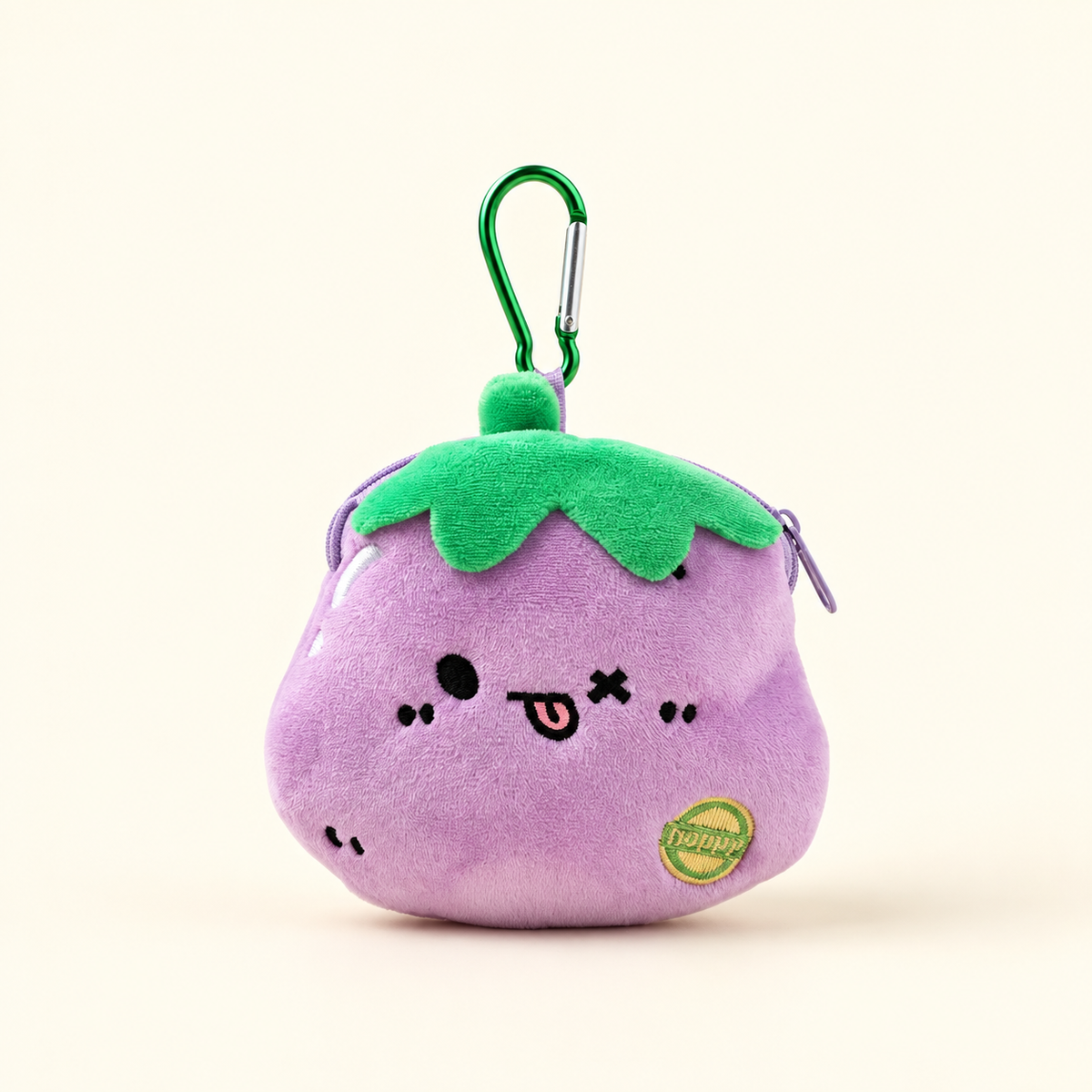 eggplant tongue plush coin purse with green clip on ivory background