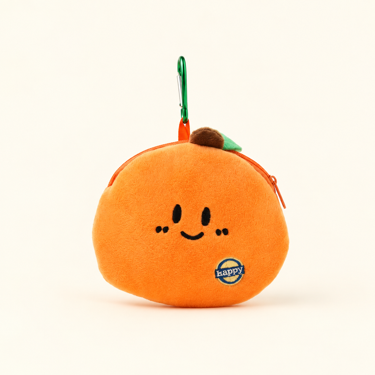 orange plush coin purse with green clip on ivory background