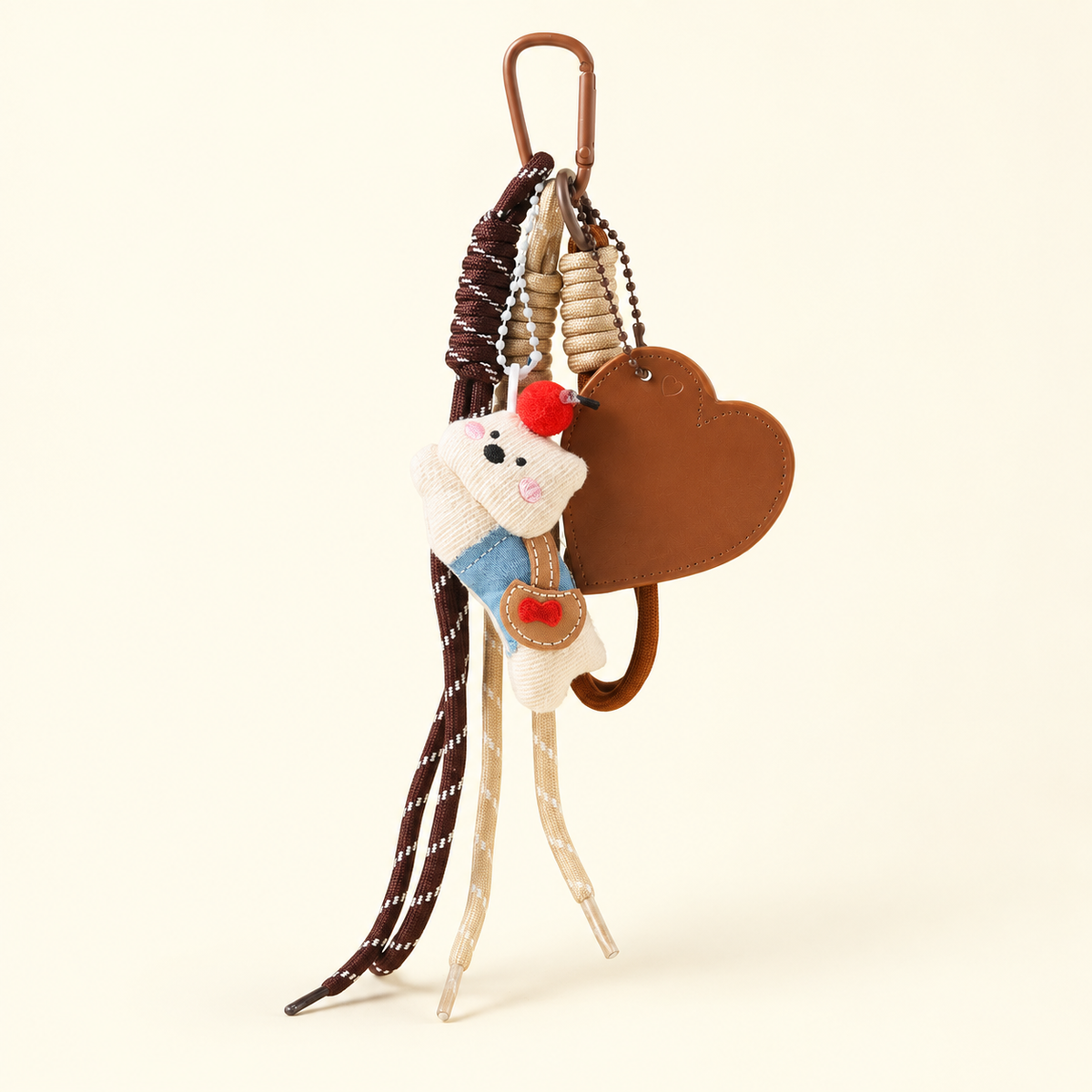 cream dog rag doll bag charm with heart and rope details