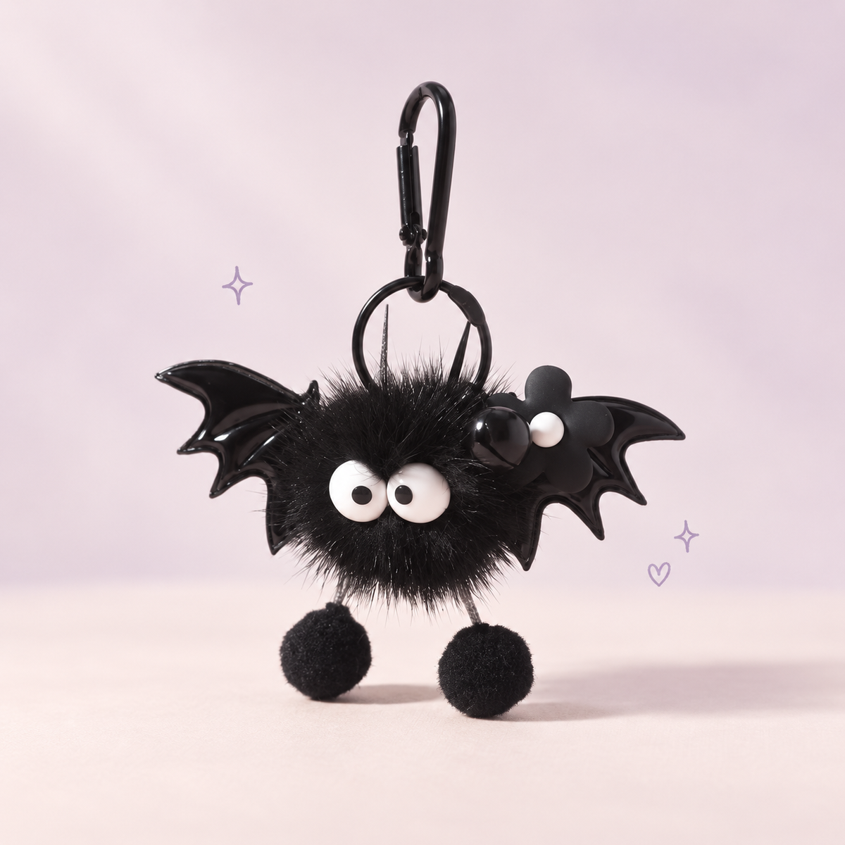 Bat Soot Plush Charm on a softly lit cream and pastel background.