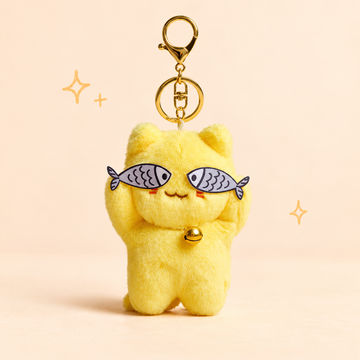Bell Cat Fish Eye Plush Charm on a softly lit cream and pastel background.