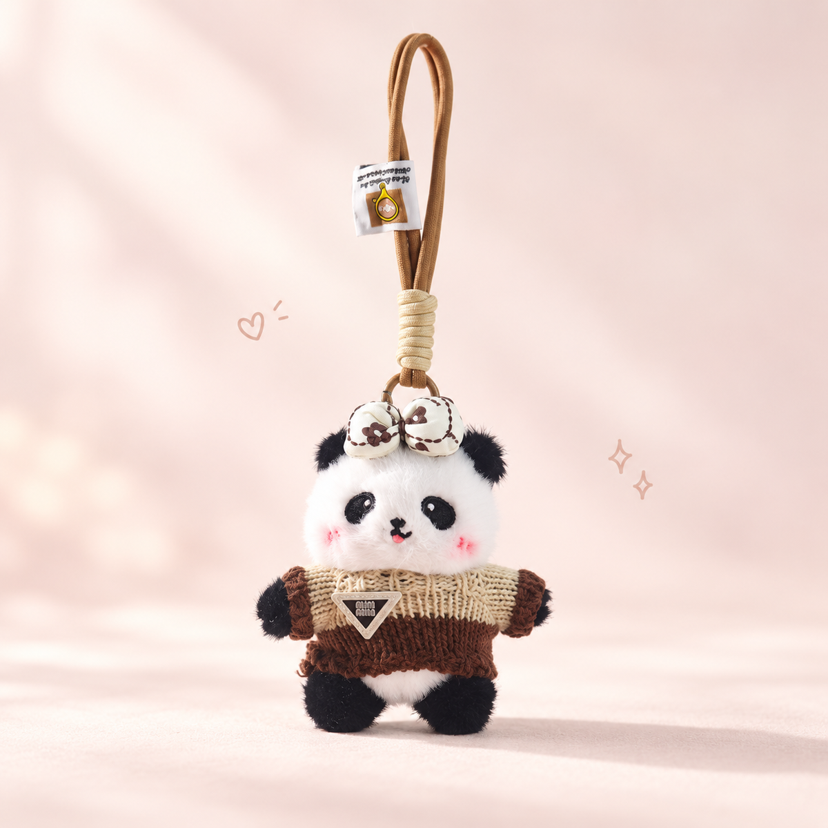 Cozy Panda Charm Keychain on a softly lit cream and pastel background.
