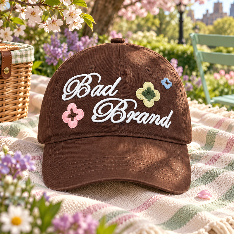 Floral Script Baseball Cap in a styled storybook scene