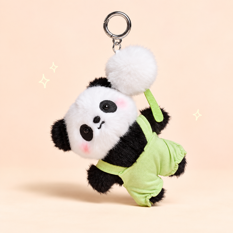 Green Overalls Panda Plush Charm on a softly lit cream and pastel background.