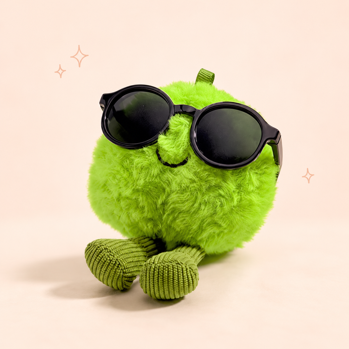 Green Pea Plush Keychain on a softly lit cream and pastel background.