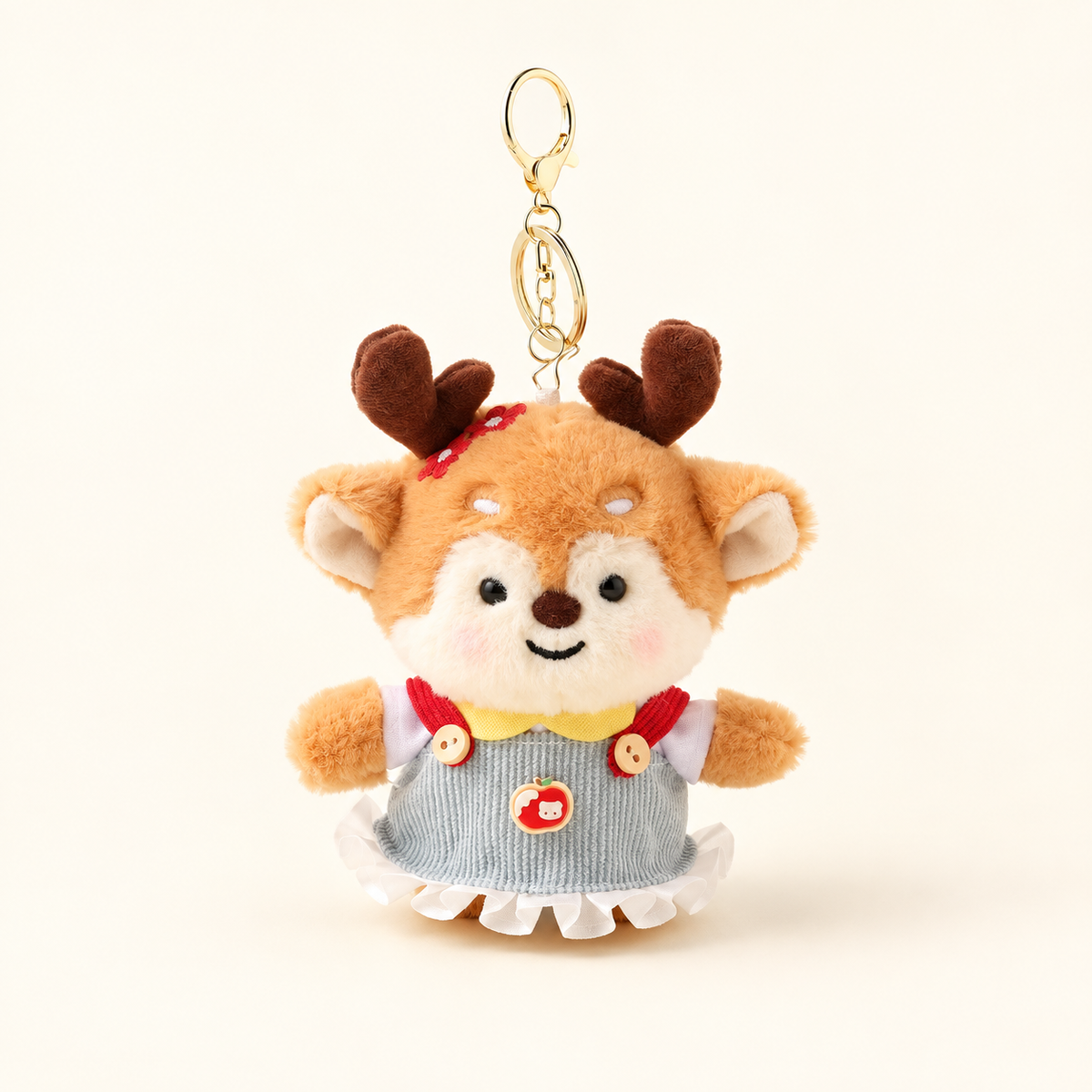 Deer plush bag charm in a blue dress with red straps and an apple accent