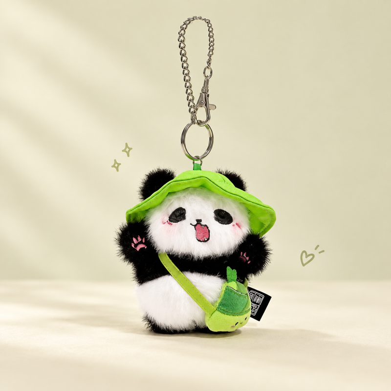 Panda plush keychain on a softly lit cream and pastel background.