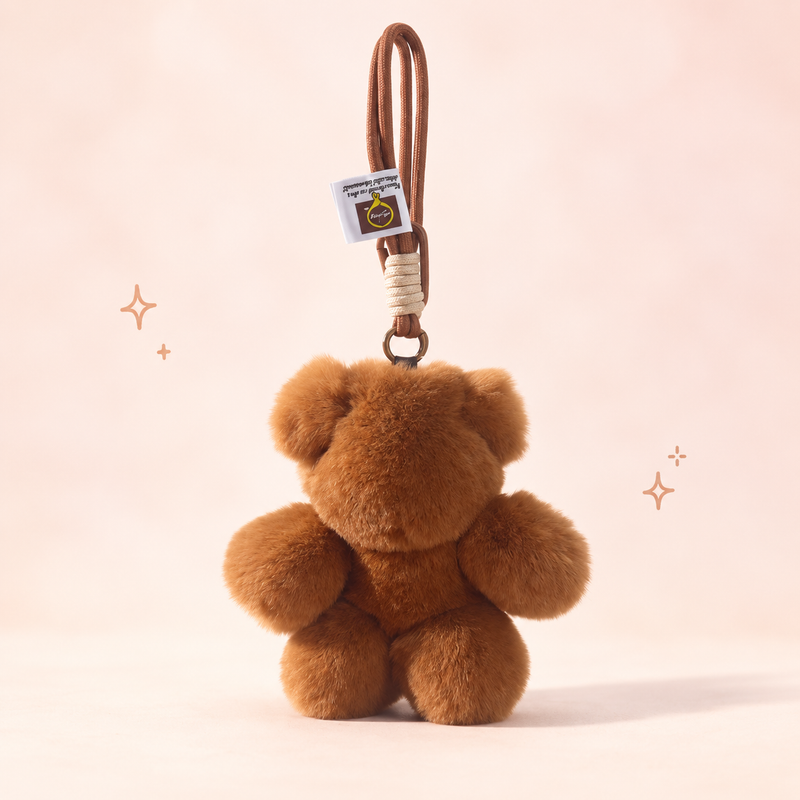 Plush Minimalist Brown Bear Charm on a softly lit cream and pastel background.