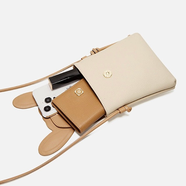 Open rabbit phone bag shown with a phone, card holder and small cosmetic item for scale