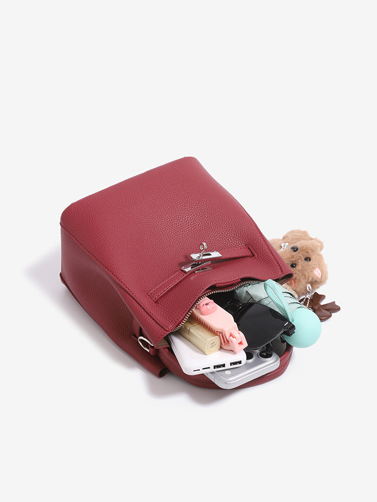 Wine red mini bucket bag open with small daily essentials inside