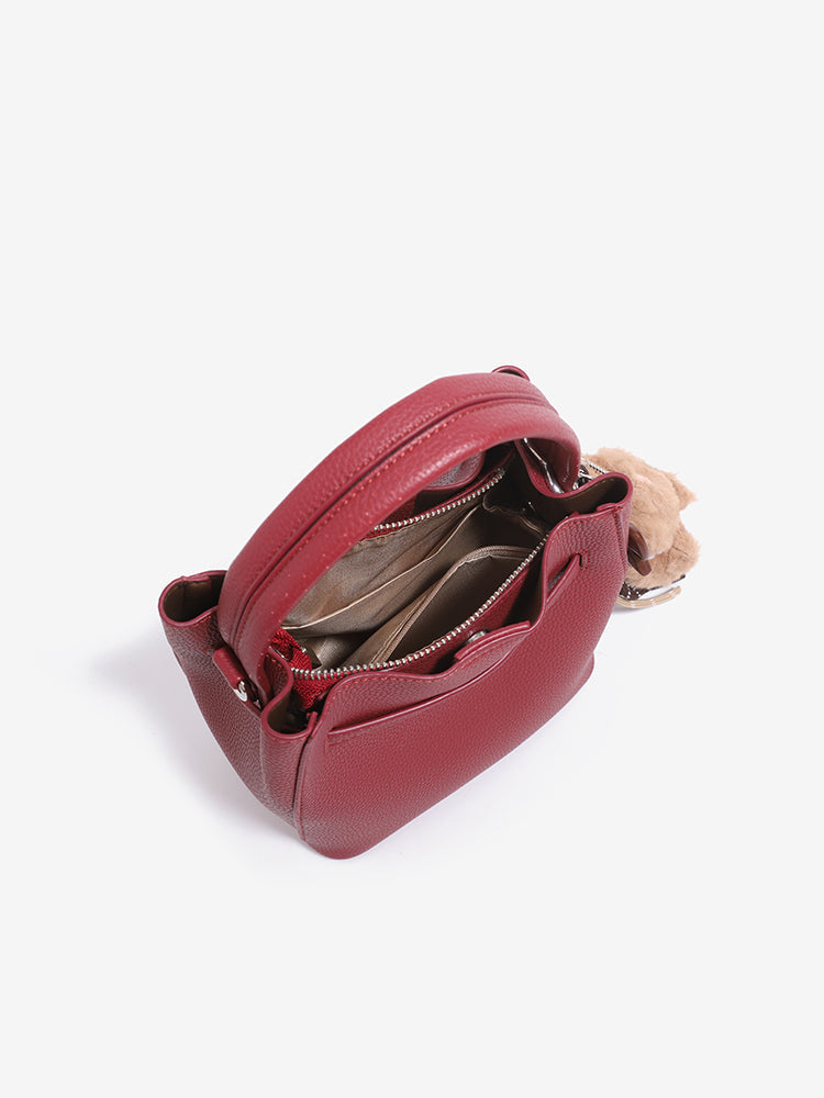 Open view of the wine red bag showing fabric-lined interior and zip pocket