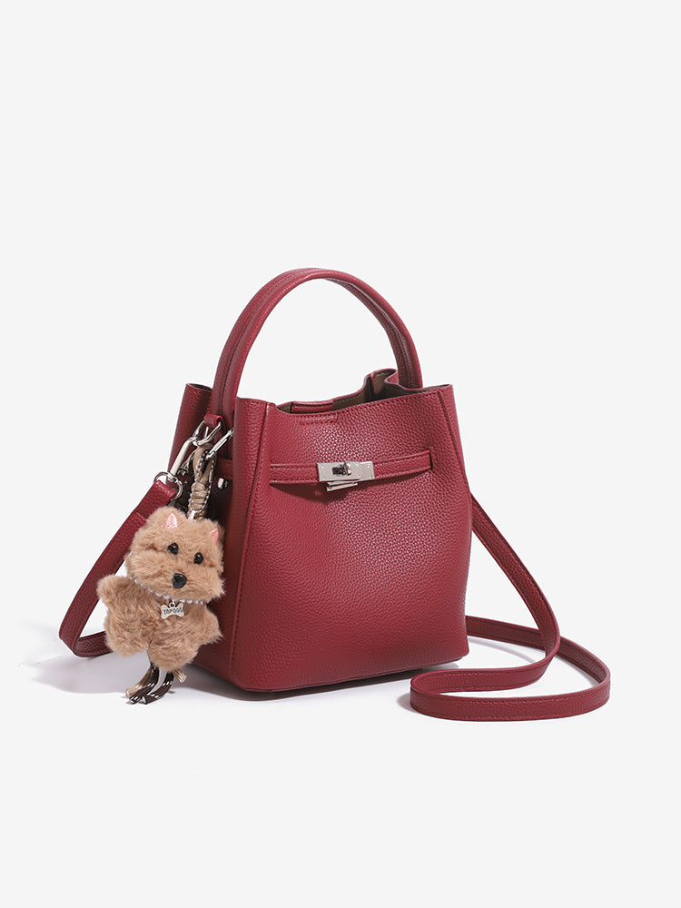 Wine red mini bucket bag with shoulder strap arranged around the base